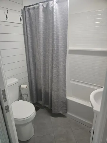 a bathroom with a toilet and shower