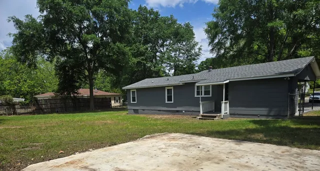 a front view of house with yard and green space