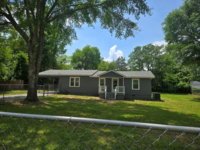 a front view of a house with a garden