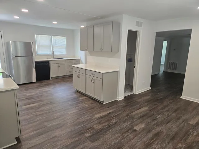 a kitchen with stainless steel appliances a refrigerator sink and cabinets