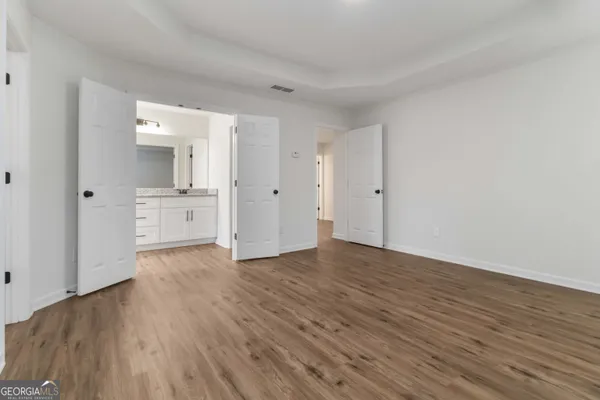 a view of a kitchen with wooden floor and a sink