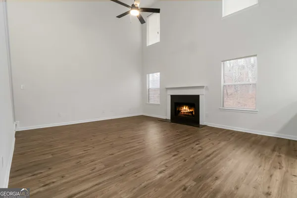 wooden floor fireplace and window in an empty room