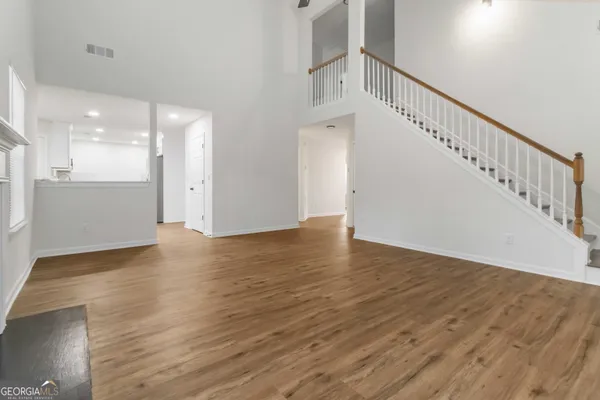 a view of an entryway with wooden floor