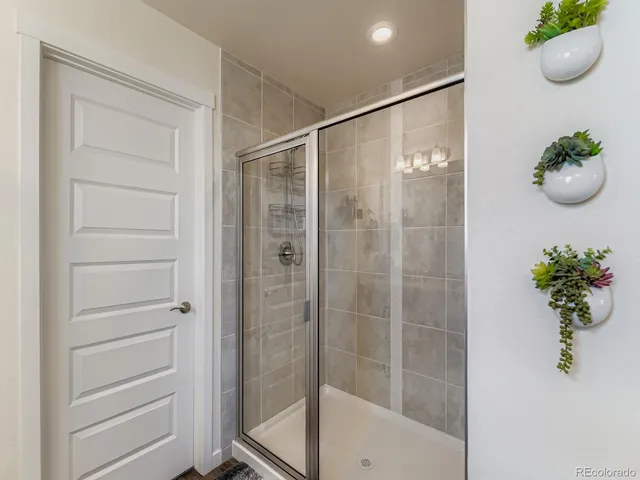a bathroom with a shower curtain and mirror
