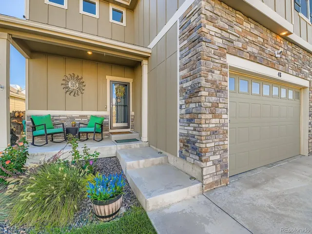 a front view of a house with outdoor seating and plants
