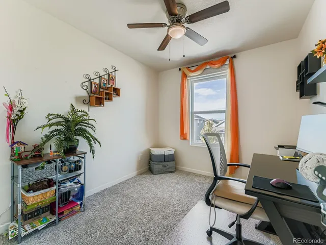 a work room with furniture and potted plants