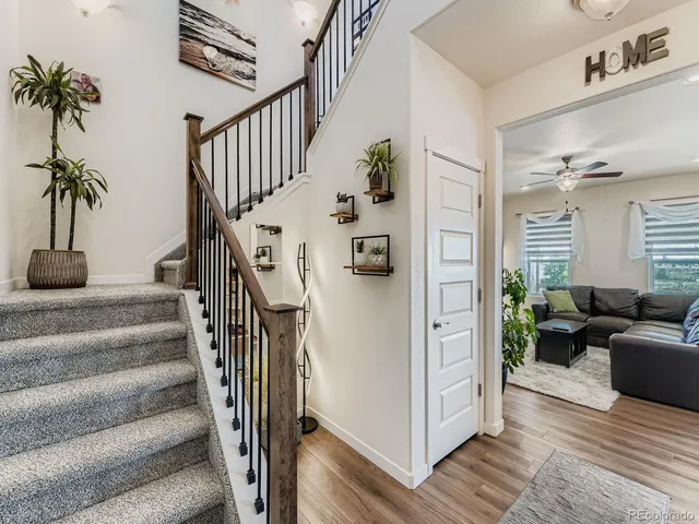 a view of entryway and hall with wooden floor