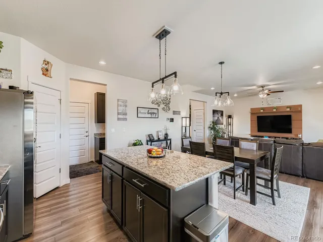 a open kitchen with stainless steel appliances granite countertop a stove and refrigerator