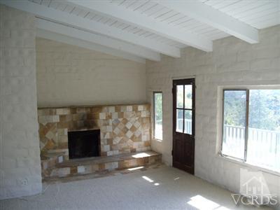 1084 Alta Vista Road Simi Valley, CA 93063 - Photo 4 of 9 a view of an empty room with a fireplace and a window