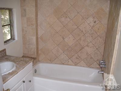 1084 Alta Vista Road Simi Valley, CA 93063 - Photo 5 of 9 a bathroom with a granite countertop sink and bathtub