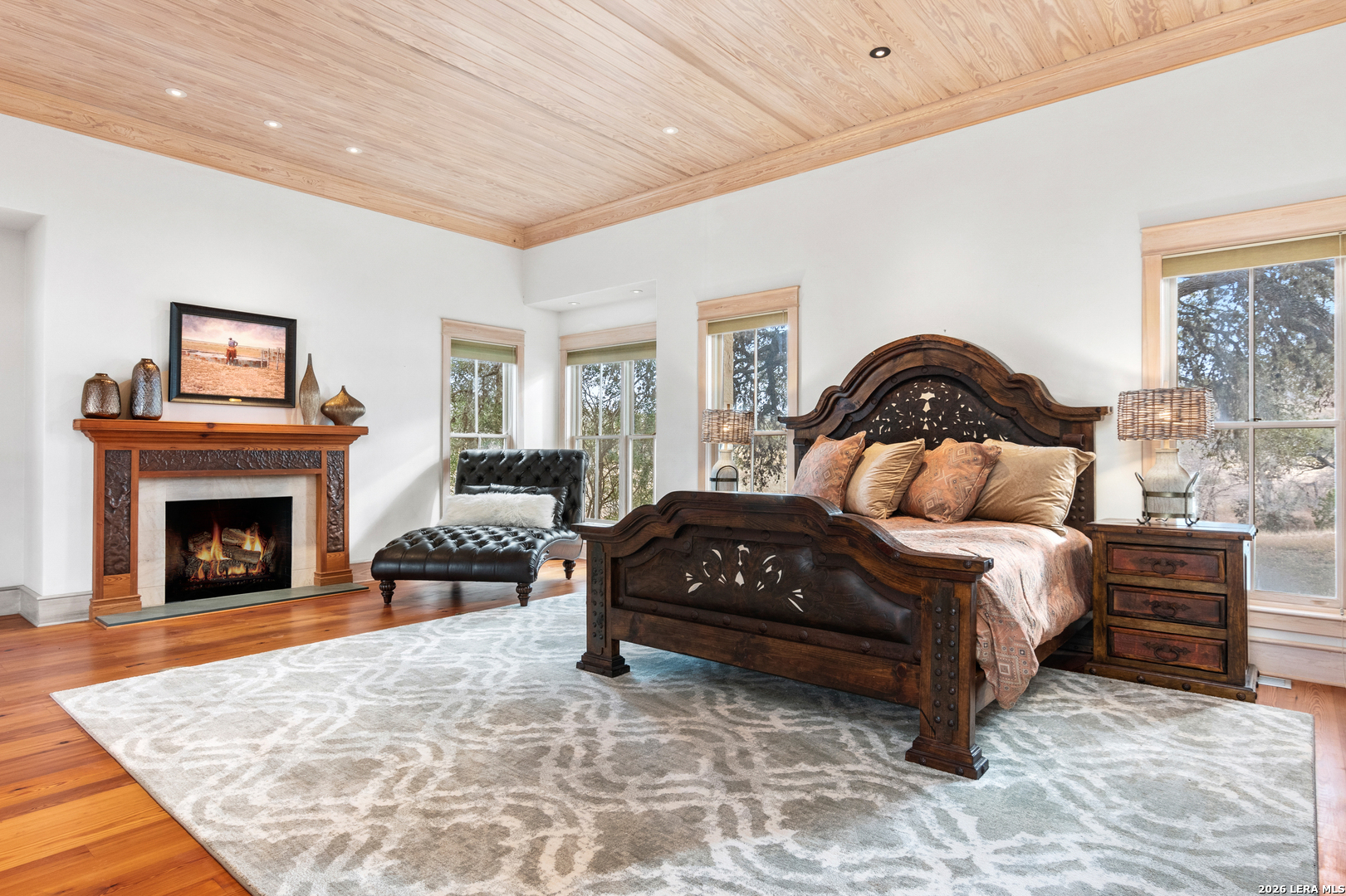 730 Eagle Ridge Road Center Point, TX 78010 - Photo 28 of 50 a bedroom with a bed and a fireplace