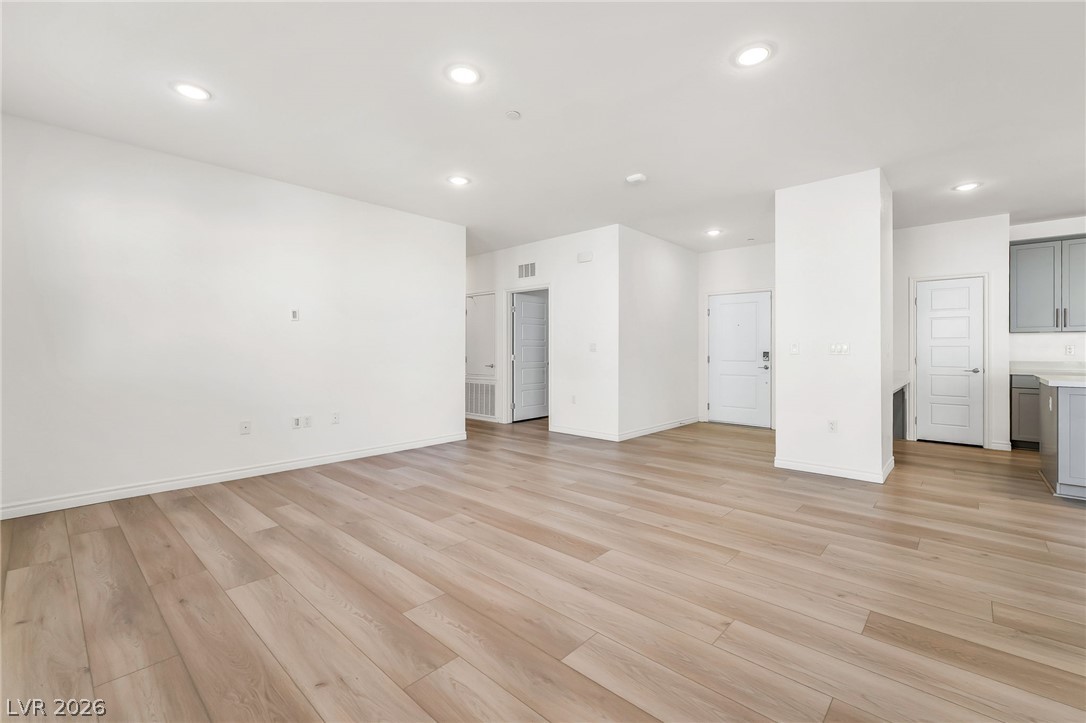 2555 Hampton Road, Unit 10108 Henderson, NV 89052 - Photo 6 of 23 Gleaming wood-look floors anchor this airy living space illuminated by modern recessed lighting.
