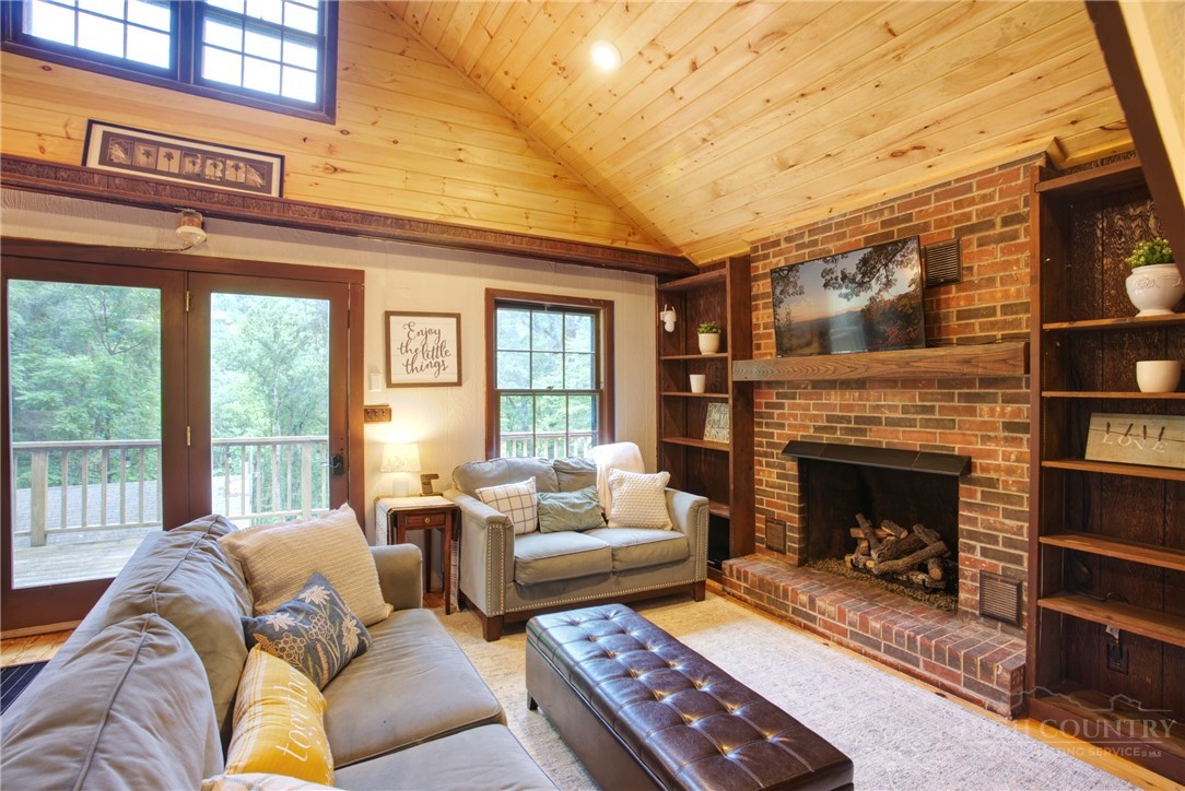 9440 Blackberry Road Lenoir, NC 28645 - Photo 7 of 30 a living room with furniture and a fireplace