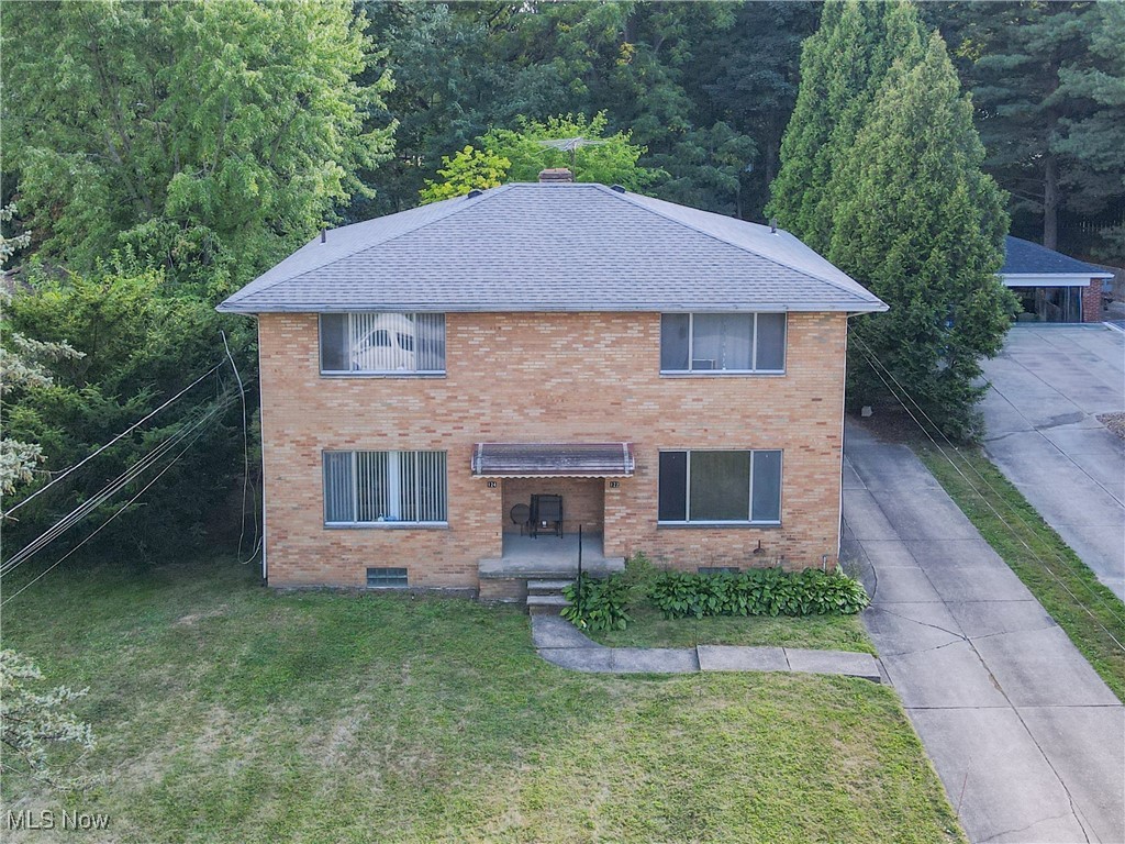122-124 Kenridge Road Akron, OH 44333 - Photo 1 of 5 Traditional-style home with brick siding, a front lawn, and a shingled roof