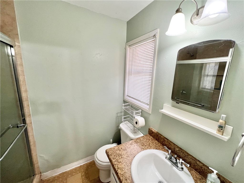 112 Rice Drive Portland, TX 78374 - Photo 21 of 30 a bathroom with a toilet sink and mirror