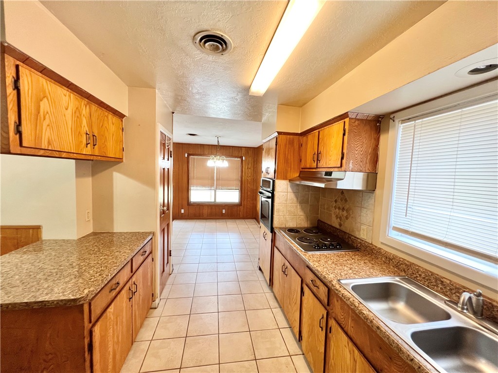 112 Rice Drive Portland, TX 78374 - Photo 7 of 30 a kitchen with a sink stove and cabinets