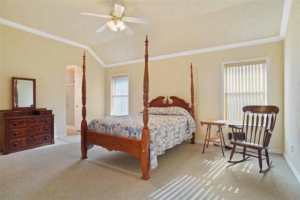809 Amon Trail Azle, TX 76020 - Photo 13 of 22 a bedroom with a bed and a chandelier
