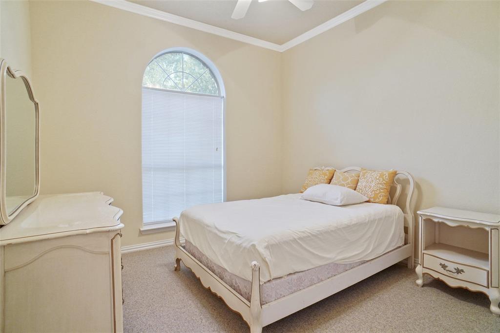 809 Amon Trail Azle, TX 76020 - Photo 18 of 22 a bedroom with a bed and a table in it