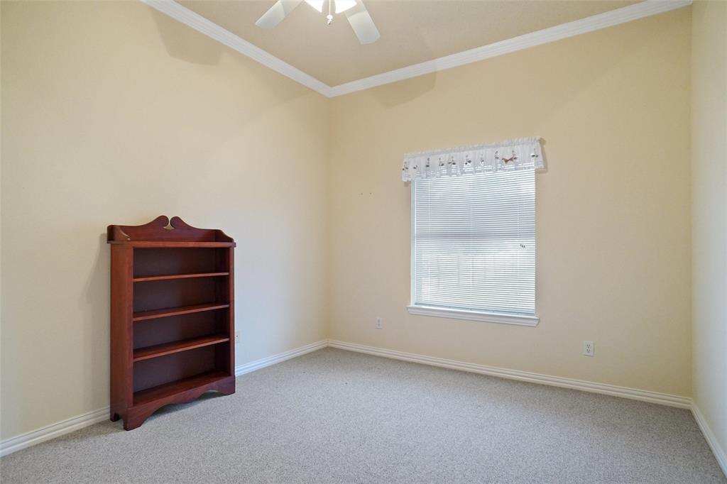 809 Amon Trail Azle, TX 76020 - Photo 19 of 22 an empty room with a dresser and a window