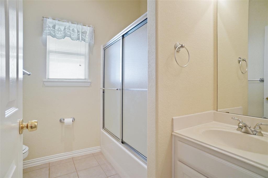 809 Amon Trail Azle, TX 76020 - Photo 20 of 22 a bathroom with a granite countertop sink a mirror and shower