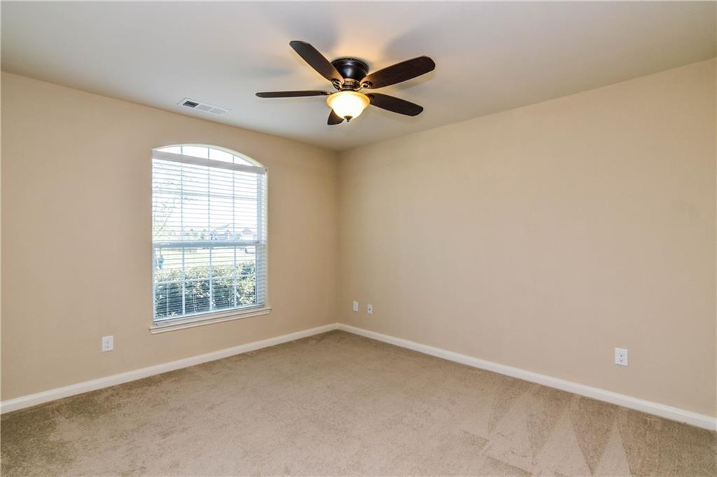 216 Mill Street Anna, TX 75409 - Photo 12 of 22 an empty room with a ceiling fan and window