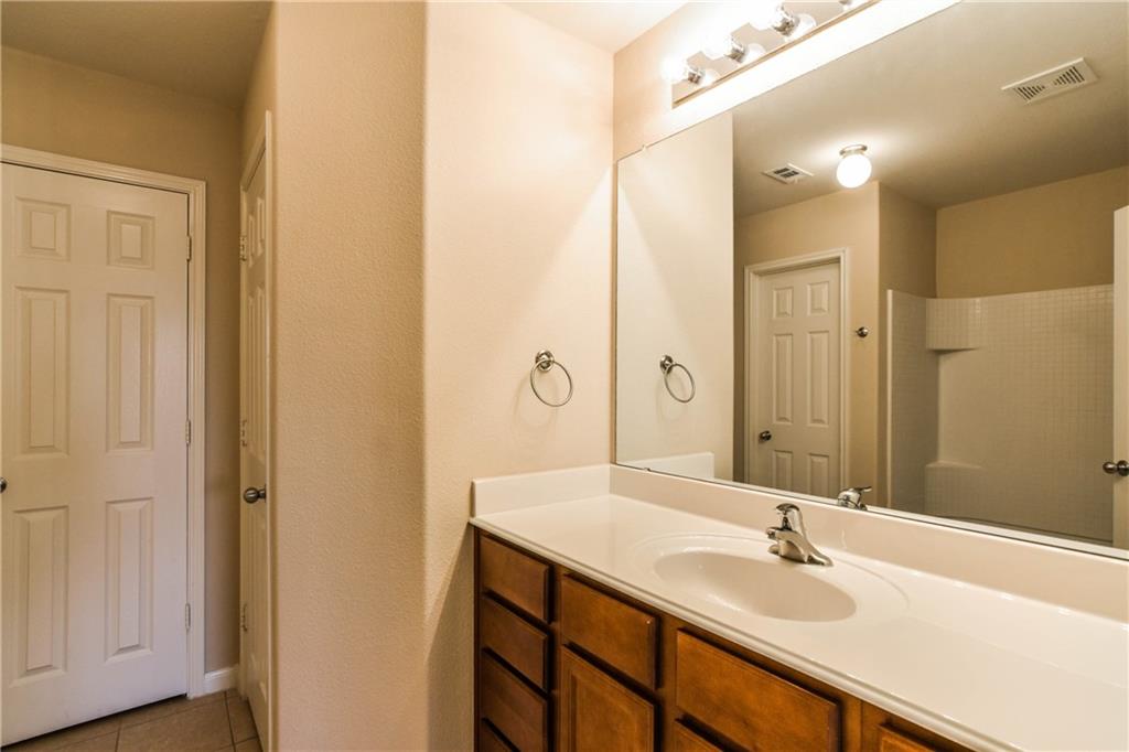 216 Mill Street Anna, TX 75409 - Photo 18 of 22 a bathroom with a granite countertop sink and a mirror