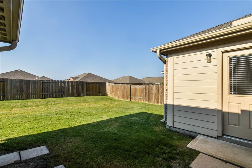 216 Mill Street Anna, TX 75409 - Photo 19 of 22 a view of a backyard with wooden fence