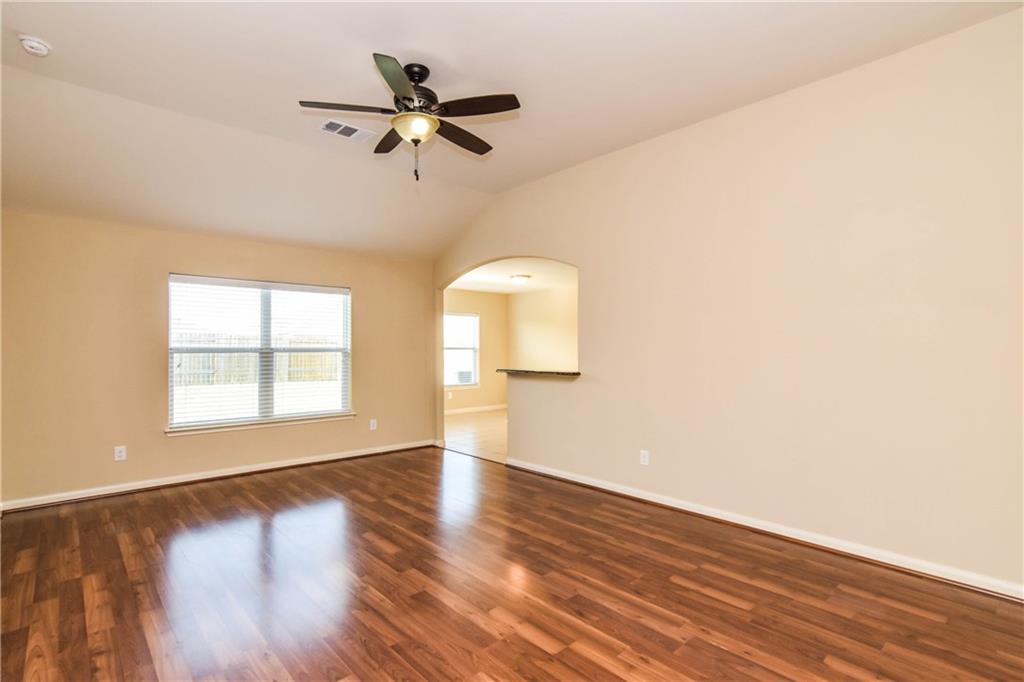 216 Mill Street Anna, TX 75409 - Photo 2 of 22 a view of a room with wooden floor fan and windows