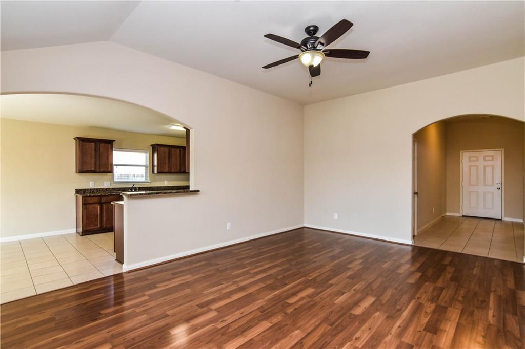 216 Mill Street Anna, TX 75409 - Photo 3 of 22 a view of a kitchen with wooden floor and a ceiling fan