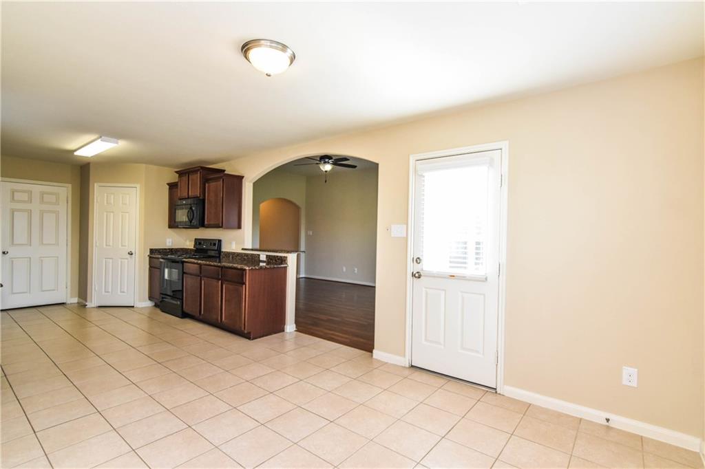 216 Mill Street Anna, TX 75409 - Photo 9 of 22 a large room with a large window and stainless steel appliances