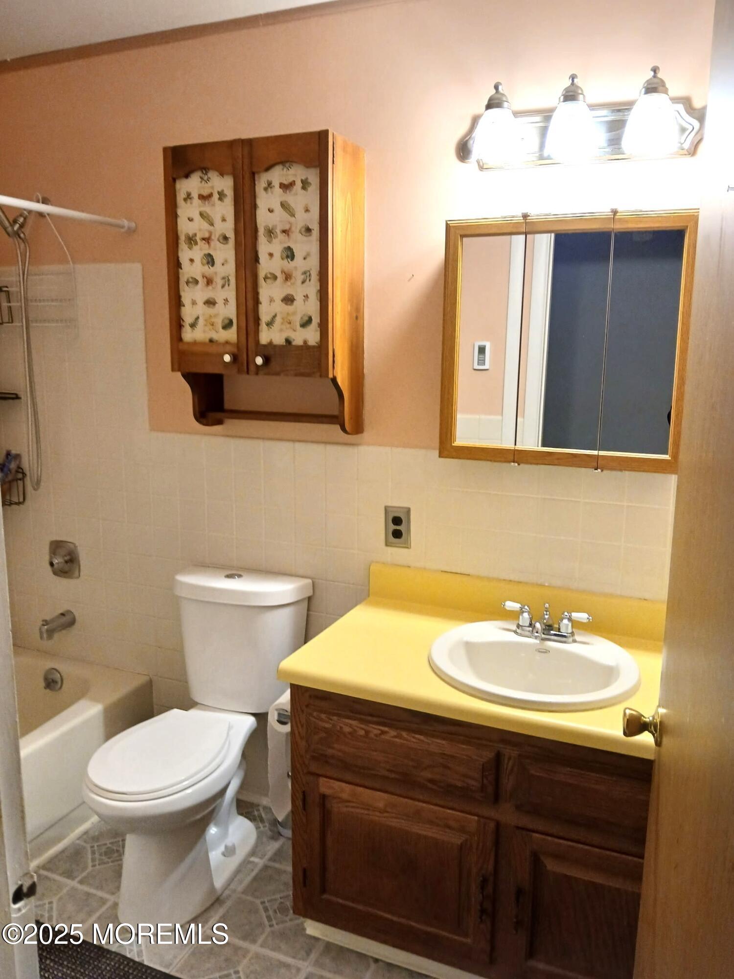 3 B Drake Street, Unit 53 Whiting, NJ 08759 - Photo 18 of 25 a bathroom with a toilet a sink and mirror