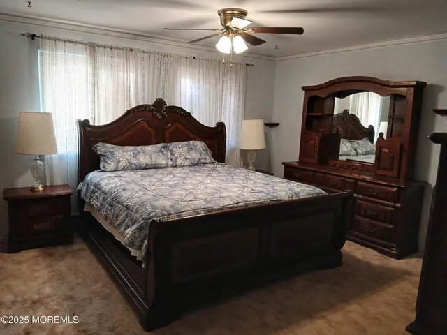 a bedroom with a bed and a mirror on dresser