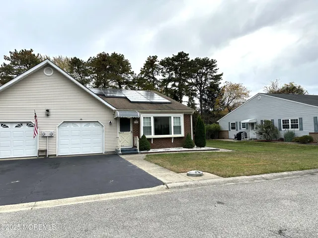 a view of a house with a outdoor space and a yard