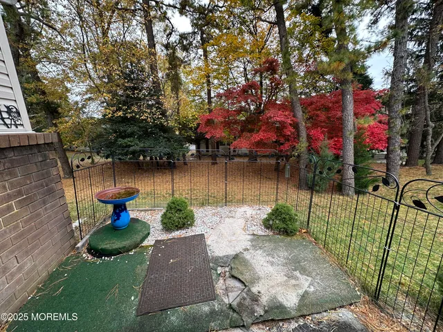 a view of a lake with a bench and trees
