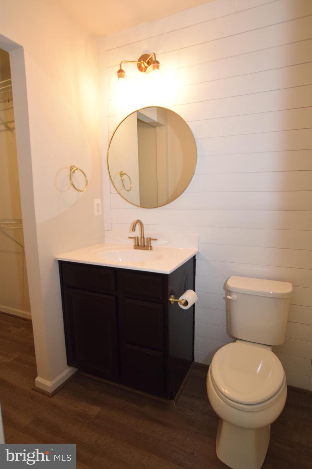 2840 Farzi Circle Locust Grove, VA 22508 - Photo 13 of 21 a bathroom with a toilet sink vanity and mirror
