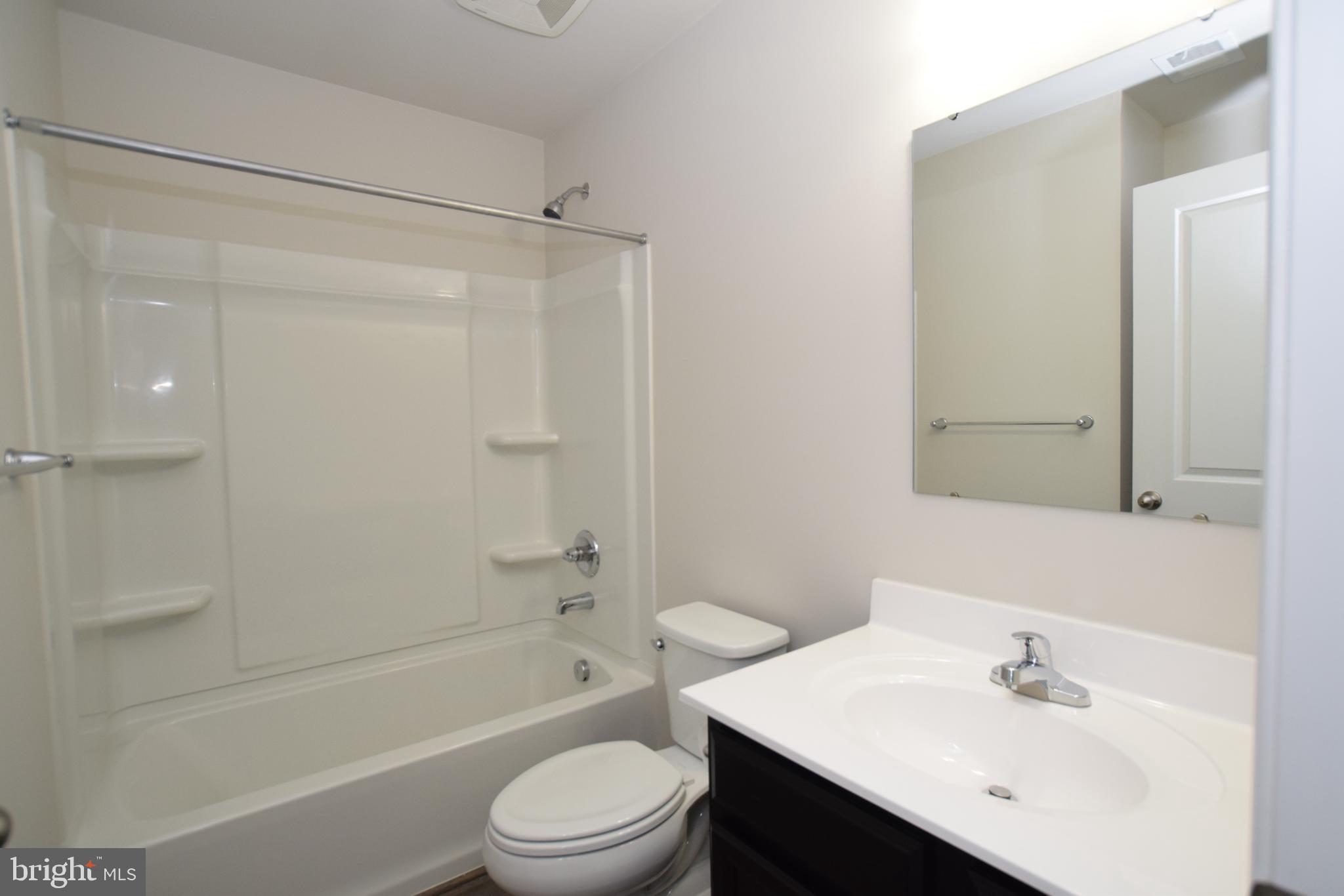 2840 Farzi Circle Locust Grove, VA 22508 - Photo 16 of 21 a bathroom with a bathtub shower sink vanity and toilet