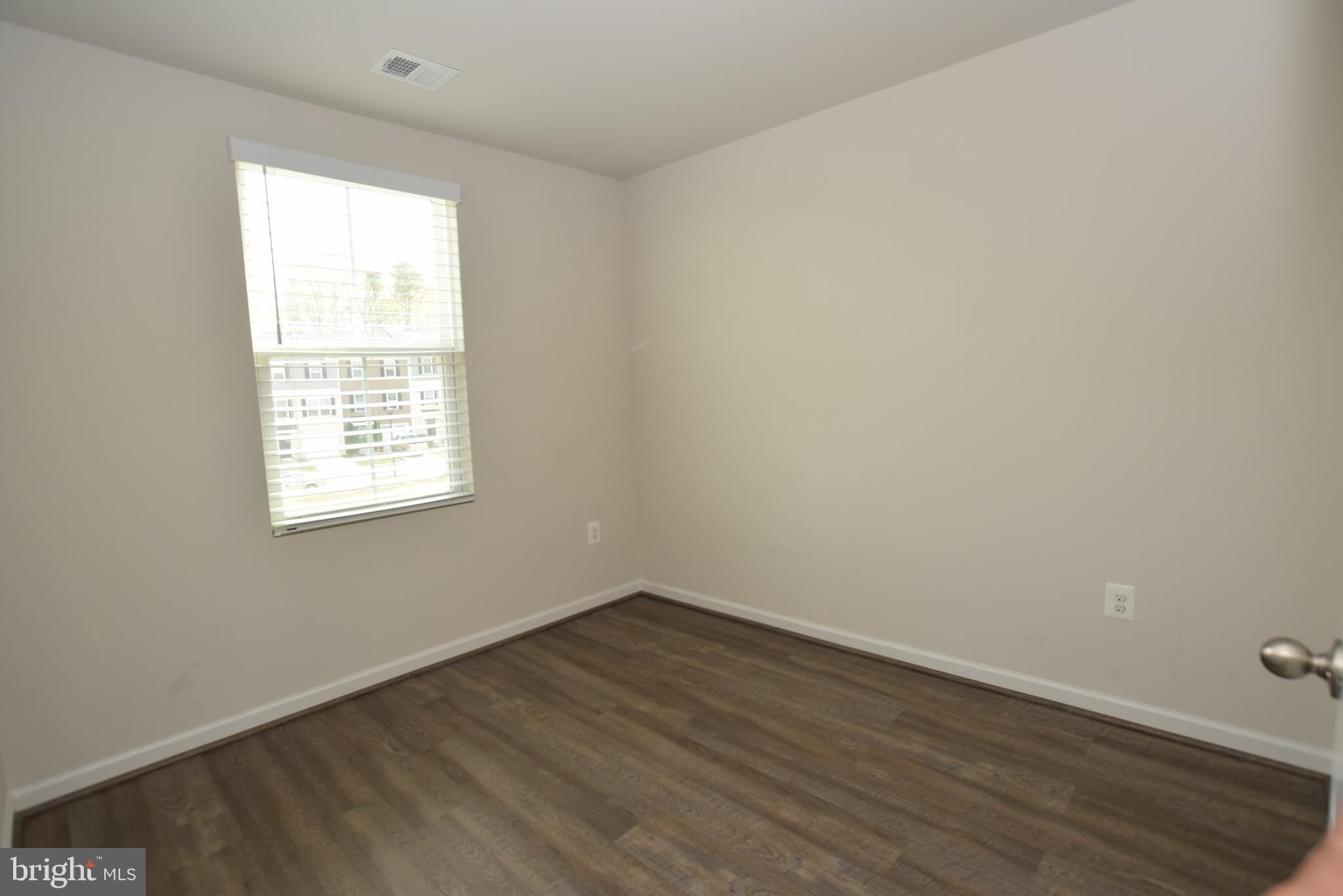 2840 Farzi Circle Locust Grove, VA 22508 - Photo 18 of 21 an empty room with wooden floor and windows