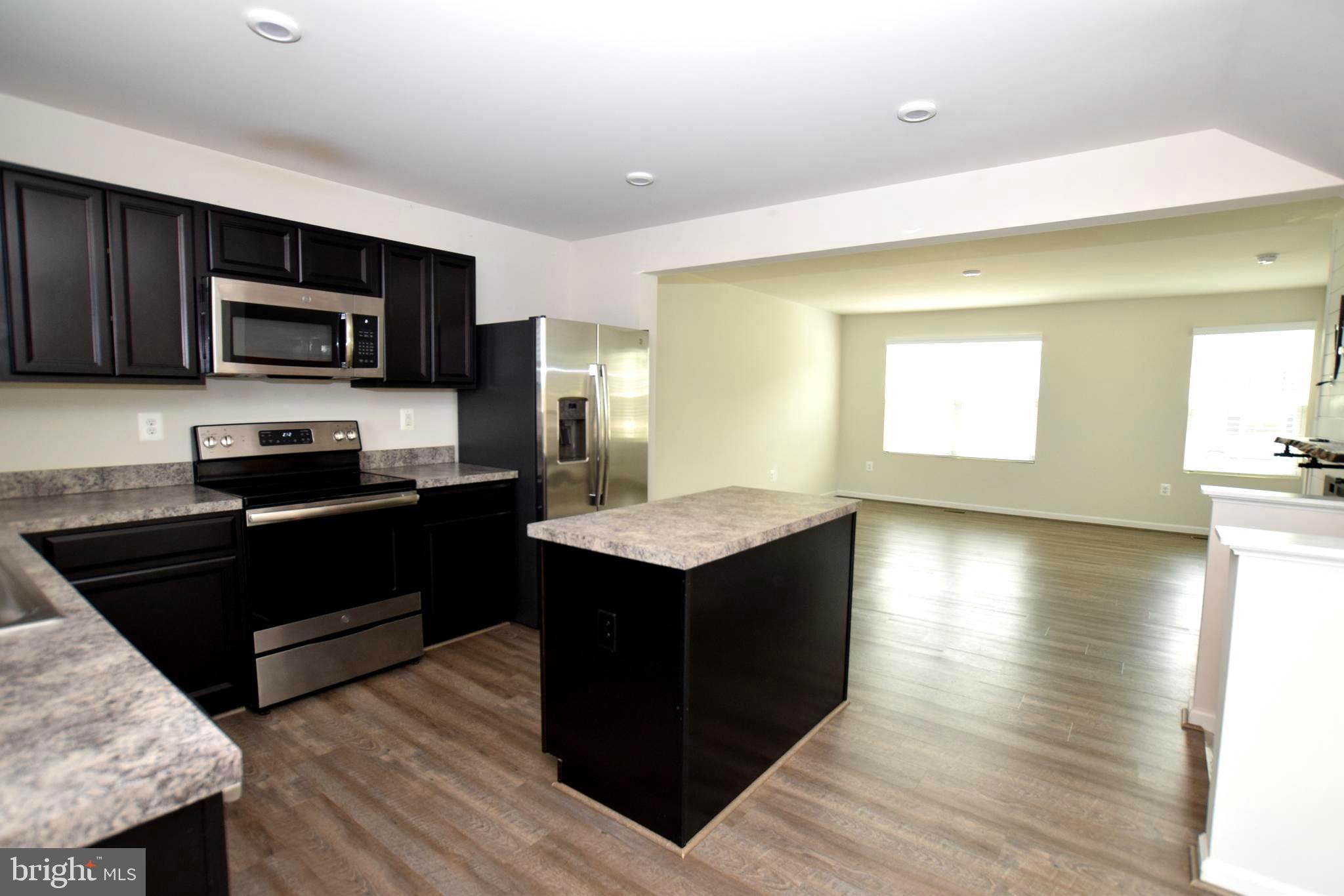 2840 Farzi Circle Locust Grove, VA 22508 - Photo 4 of 21 a kitchen with a sink and steel appliances