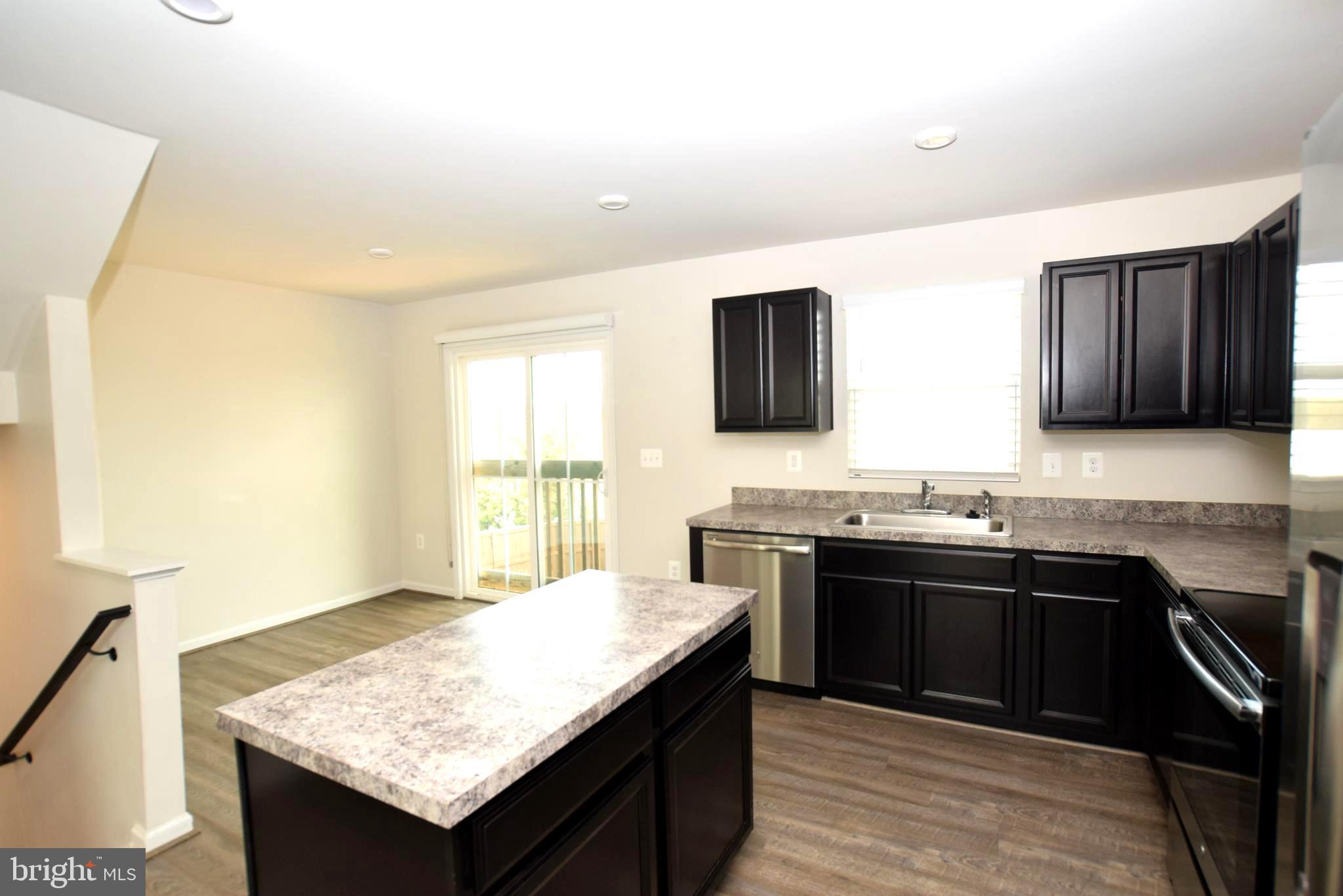 2840 Farzi Circle Locust Grove, VA 22508 - Photo 6 of 21 a kitchen with stainless steel appliances granite countertop a sink stove and refrigerator