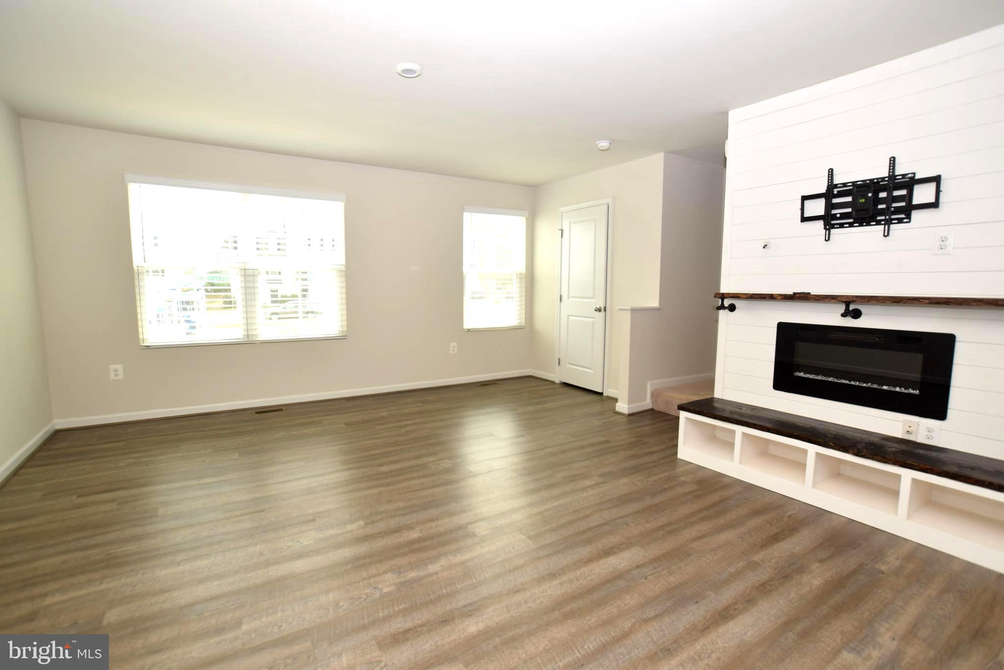 2840 Farzi Circle Locust Grove, VA 22508 - Photo 8 of 21 an empty room with wooden floor and windows