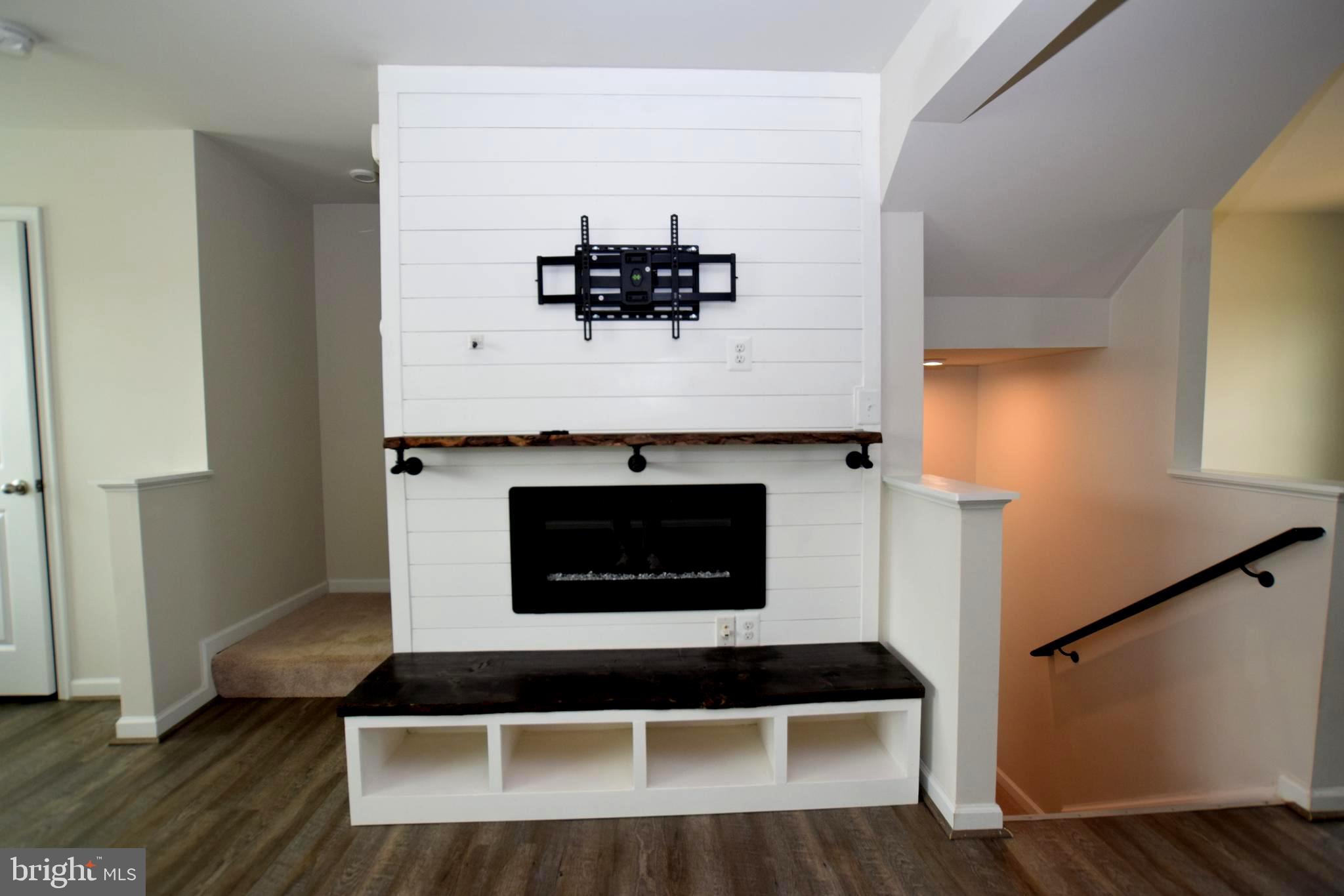 2840 Farzi Circle Locust Grove, VA 22508 - Photo 10 of 21 a living room with a fireplace and a wooden floor