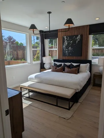 a living room with furniture a large window and a chandelier