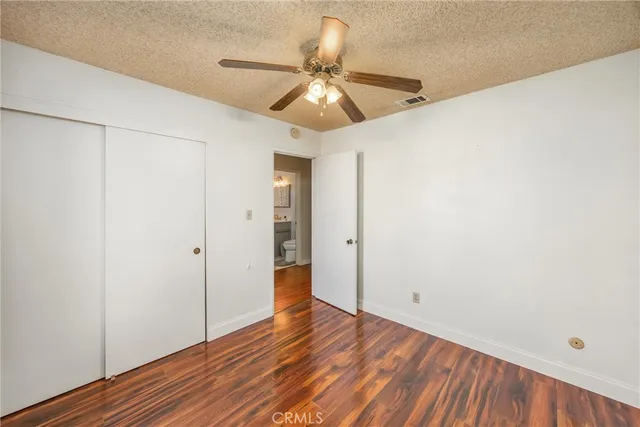 a view of an empty room and wooden floor