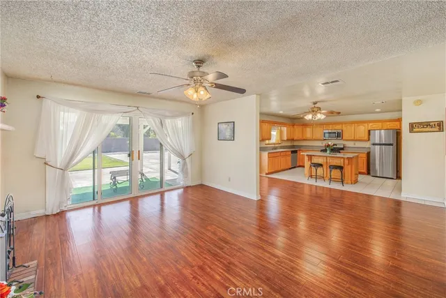 a view of an dining room with wooden floor and a kitchen