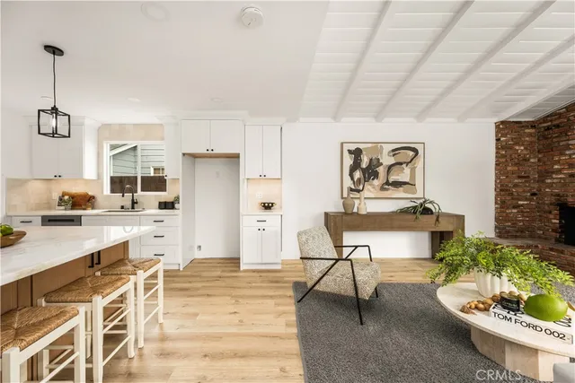 a living room with furniture wooden floor and a large window