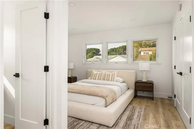 a living room with white cabinets and a book shelf