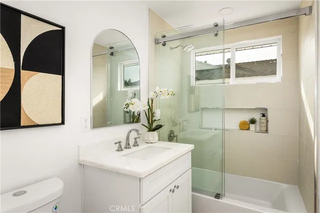 a bedroom with a large bed and a painting on the wall