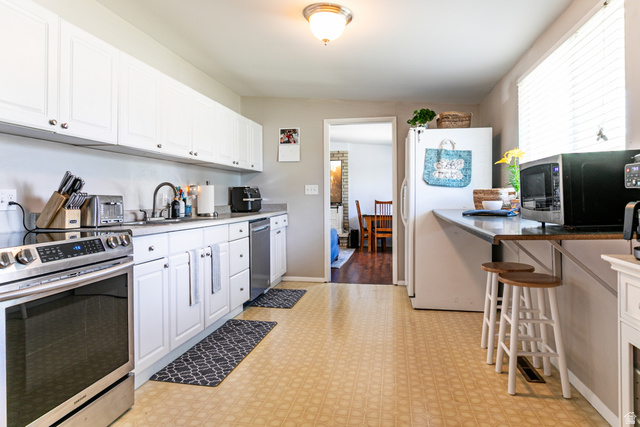 1619 Davis Drive Layton, UT 84041 - Photo 8 of 27 Kitchen featuring light-toned flooring and white cabinetry