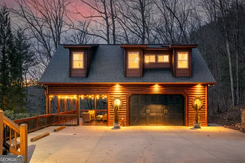 a front view of a house with yard and parking