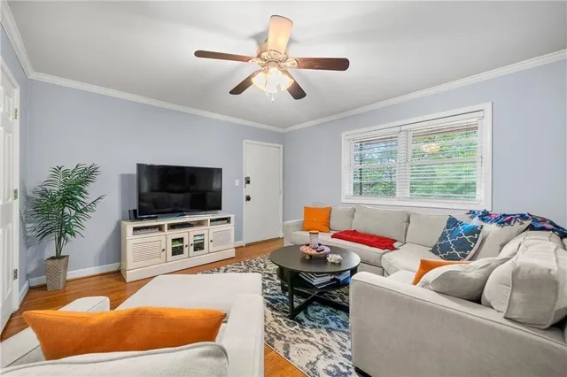 a living room with furniture and a flat screen tv
